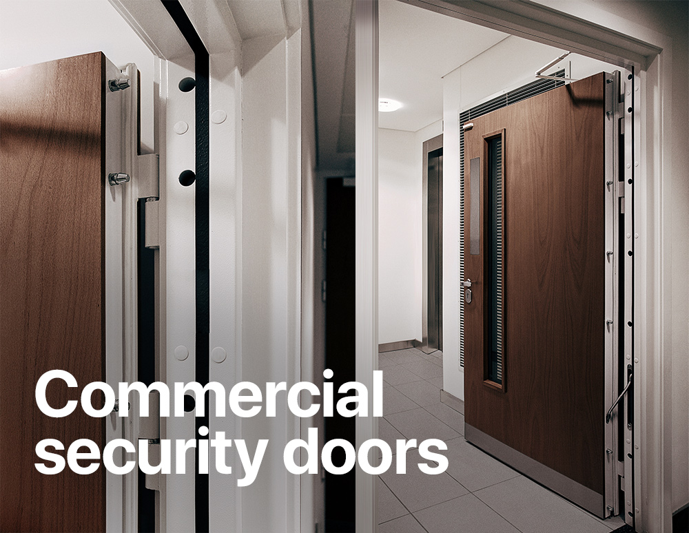 Open wood-finished commercial security doors with visible steel construction and locking bolts, with the text “Commercial security doors.”