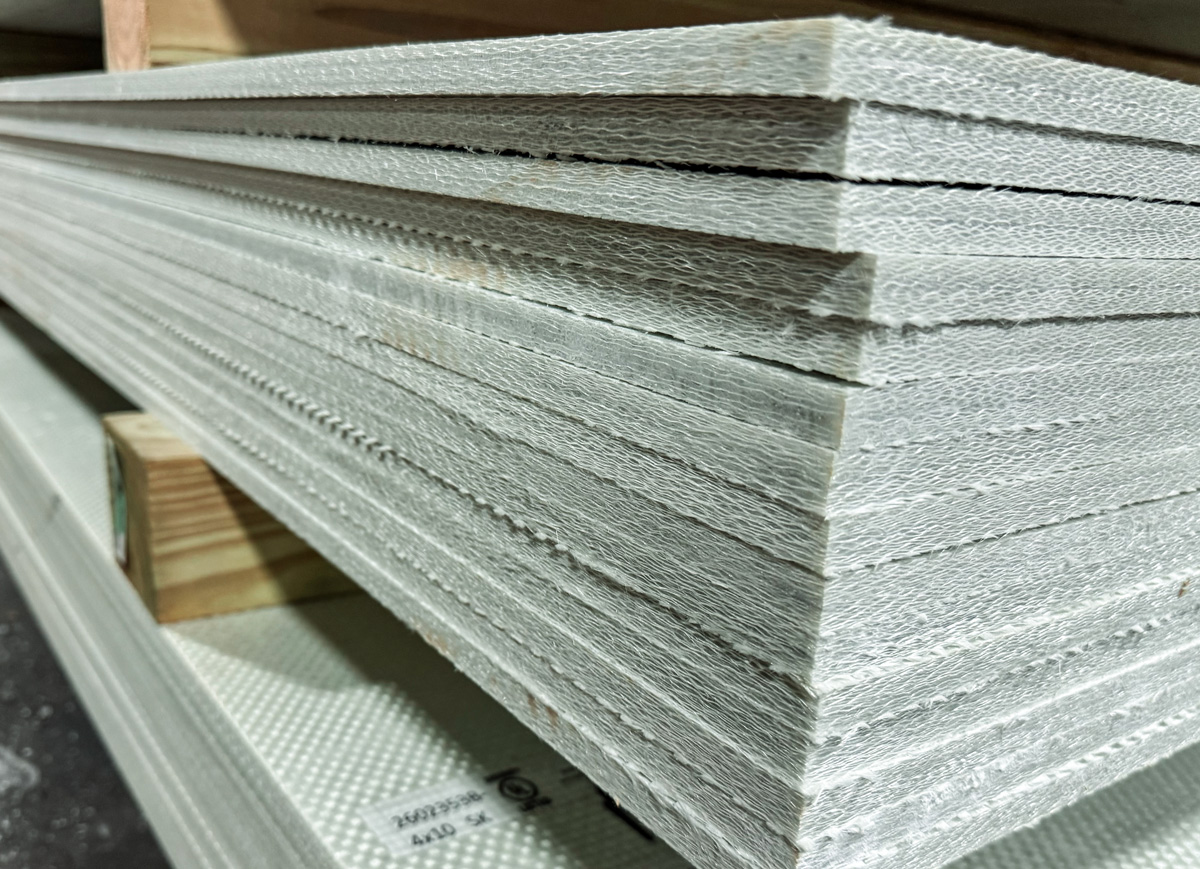Stacked Armored Doors ballistic fiberglass panels showing multiple thicknesses and the dense woven composite construction.