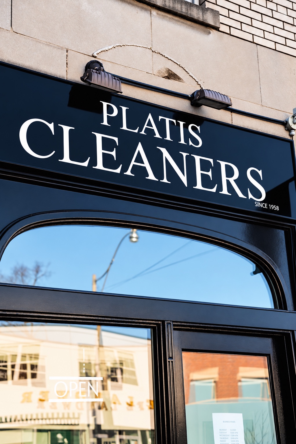 Platis Cleaners storefront with its sign and open entrance