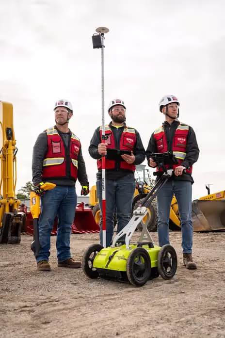 Three GPRS Project Managers in the field with an EM locator, an GPR device, and a GNSS RTK device.
