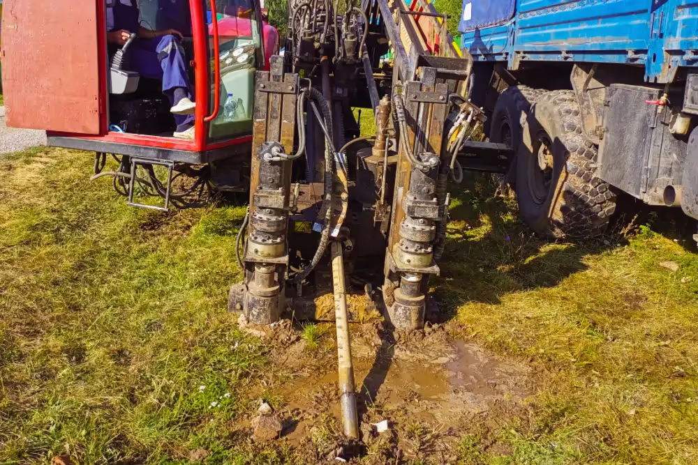 A horizontal directional drilling machine boring into the ground.