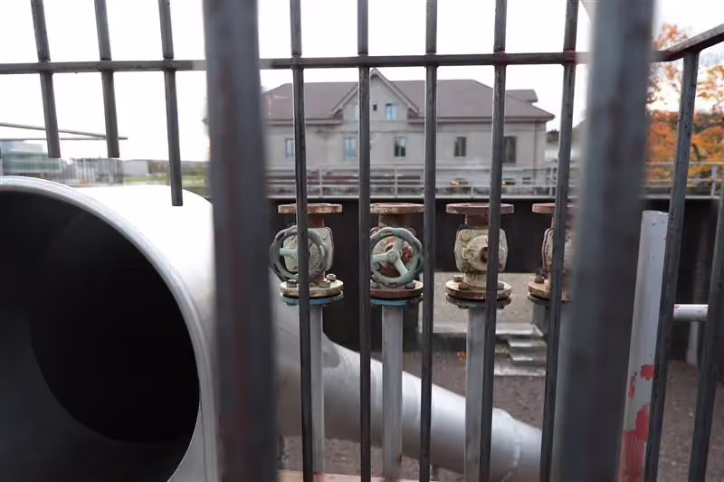 Valves seen through prison bars.