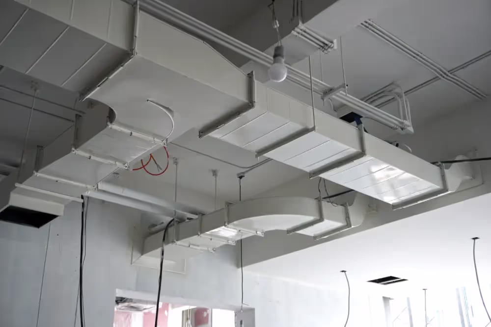 HVAC ductwork on the ceiling of a building as viewed from the floor.