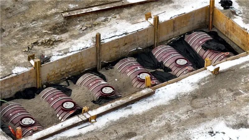 New underground storage tanks being installed on a construction site.