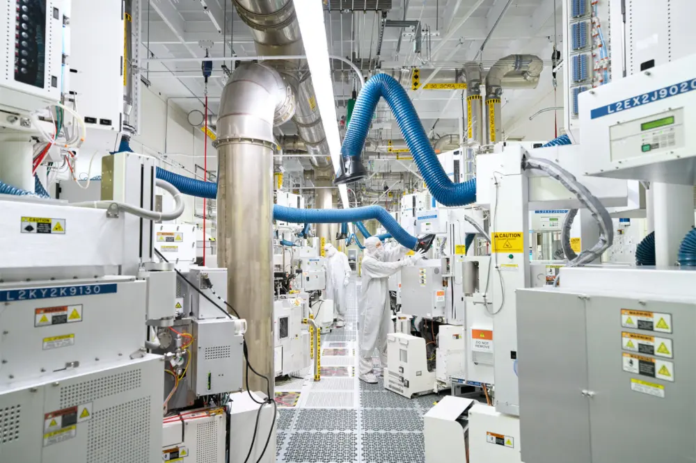 Workers in cleanroom suits in a manufacturing facility.