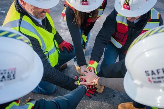 A group of GPRS Team Members putting their hands together in a circle