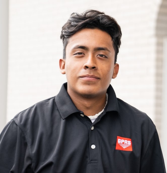 GPRS Project Manager Javier Mendez, a Latino man with short dark hair, in a black GPRS logo polo shirt.