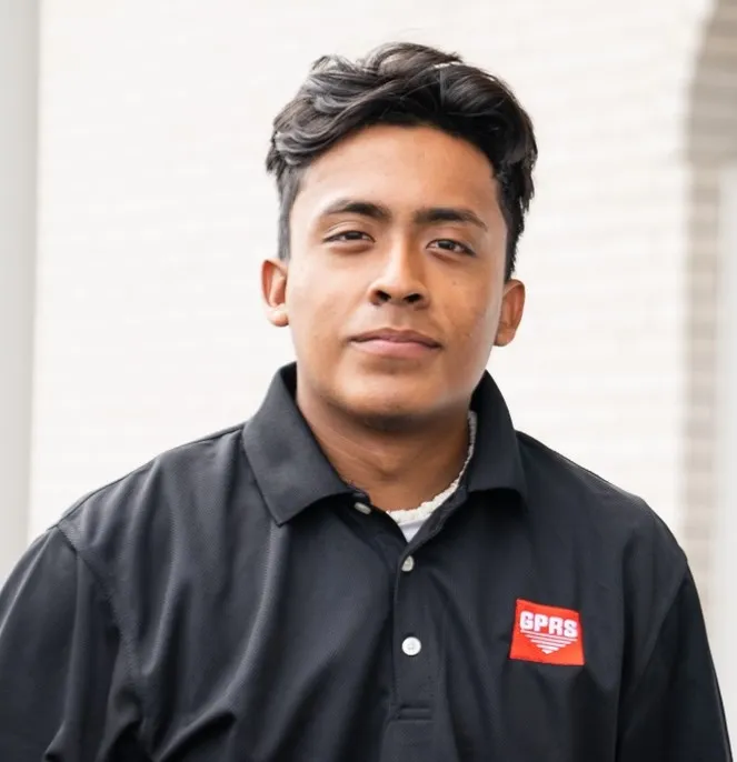 GPRS Project Manager Javier Mendez, a Latino man with short dark hair, in a black GPRS logo polo shirt.