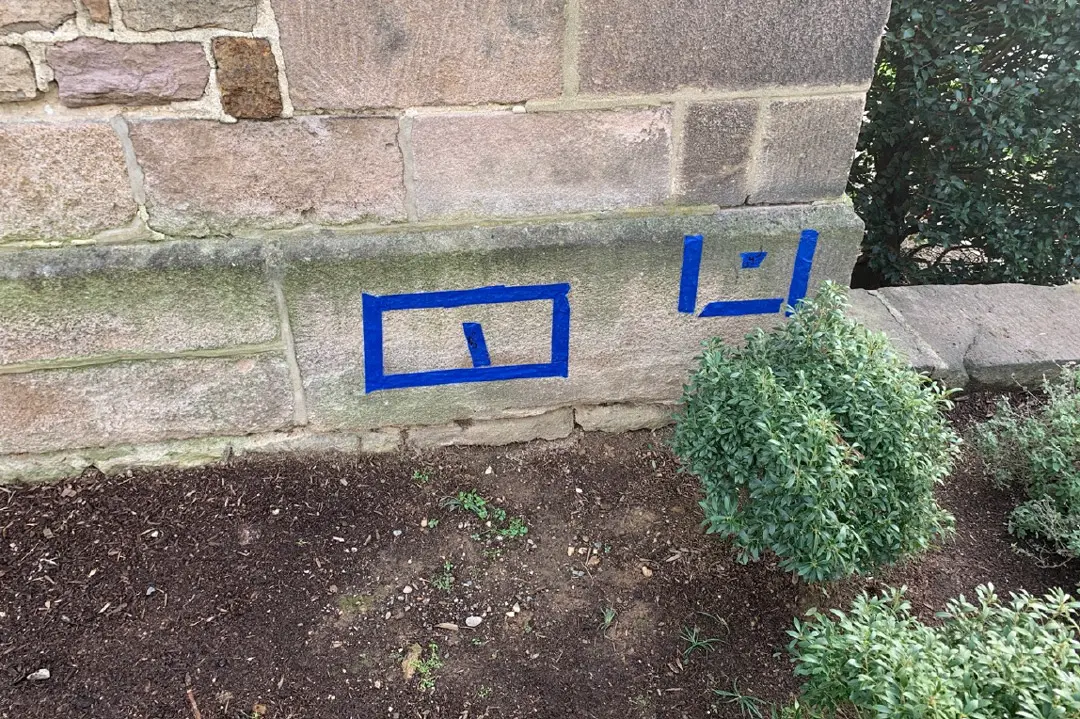 Painter’s tape marks out findings on a stone block.