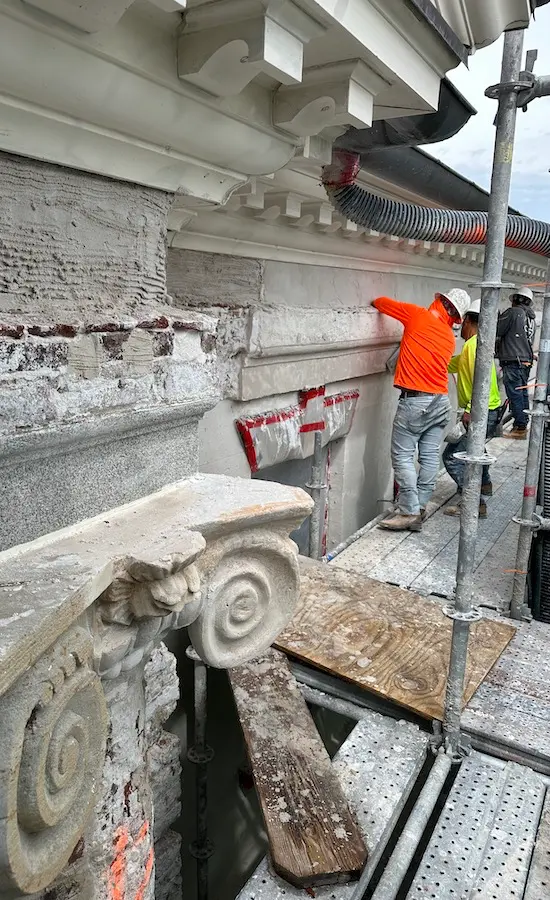 Workers restoring the exterior of the Charleston County Courthouse.