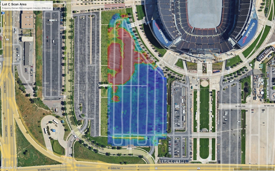 An aerial photo of a parking lot to the lower left of a football stadium with red, orange, yellow, green and blue electromagnetic locator data overlayed onto the image.