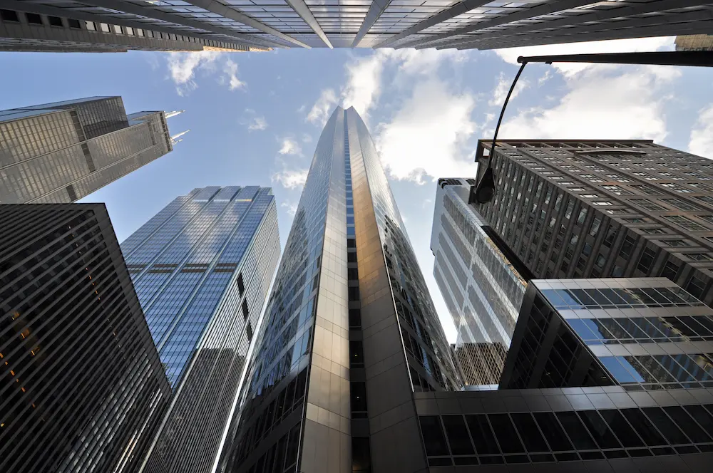 An extreme perspective shot from ground level capturing the full height of Chicago's FiDi skyscrapers
