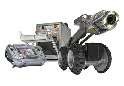 The silver crawler with four black tires is shown on the right side, with a handheld display shown to the left of it