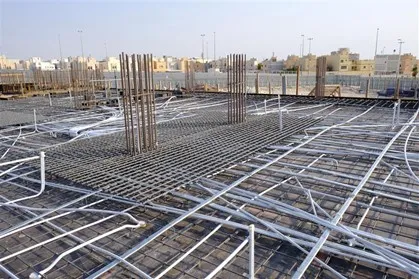A large amount of conduit going in all directions on a job site before the concrete is poured over it.