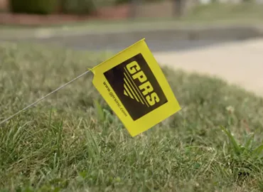 A yellow flag with the GPRS logo placed in a grassy area.