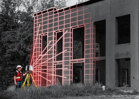 A worker in a white helmet, red vest, black shirt, and jeans utilizing a laser scanner that is emitting six diagonal red lines onto a black and white structure. Horizontal and vertical lines are shown where the lines hit the structure to form a checkerboard pattern.