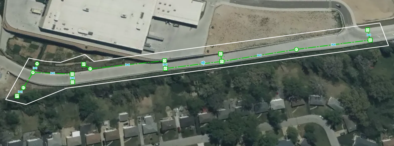 Green lines within a white outline placed on a satellite image representing underground sewer lines. 