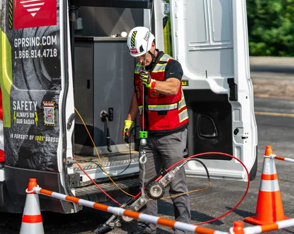 A GPRS Video Pipe Inspection Project Manager deploying a robotic mainline crawler CCTV camera to scope a sewer line