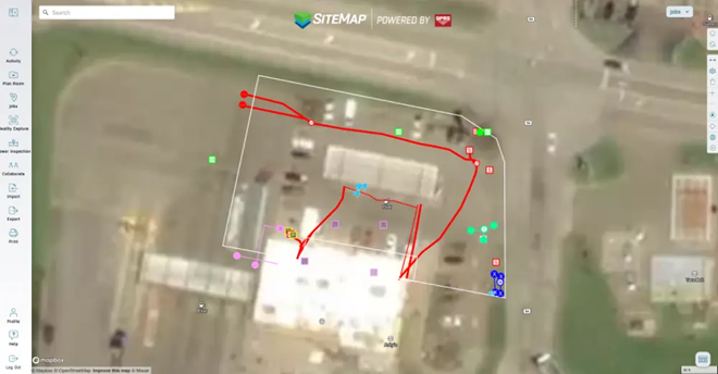 A satellite image of a facility on the SiteMap platform with white, red, blue, and green lines representing subsurface utilities and the scan area.