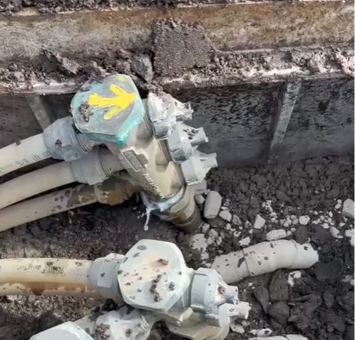 A pipe with a yellow arrow pointing towards it, indicating direction or focus on the pipe's location.