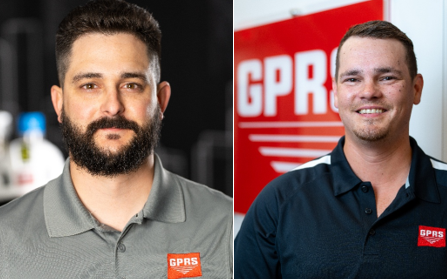 Two men wearing polo shirts with the GPRS logo in the left chest area, the one of the left wearing a light grey polo and the one of the right wearing a black one. 