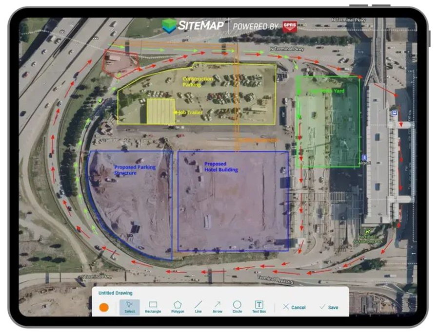 Overhead aerial map displayed on a tablet showing a construction site layout with labeled zones and traffic flow. The image includes colored outlines: a yellow area labeled “Construction Parking” and “Job Trailer,” a green “Lay Yard” on the right, and blue sections marked “Proposed Parking Structure” and “Proposed Hotel Building” in the lower half. Red and green arrows indicate vehicle circulation routes around the perimeter roads. Surrounding streets, parked cars, and existing infrastructure are visible. A header reads “SITEMAP Powered by GPRS,” and a toolbar with drawing tools appears along the bottom of the screen.