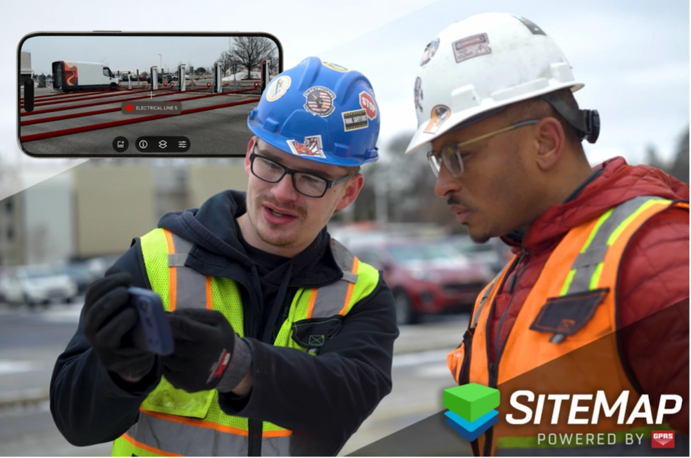 GPRS project manager and general contracting foreman look at buried lines on a phone screen displaying accurate data on the SiteMap platform to minimize subsurface damage.