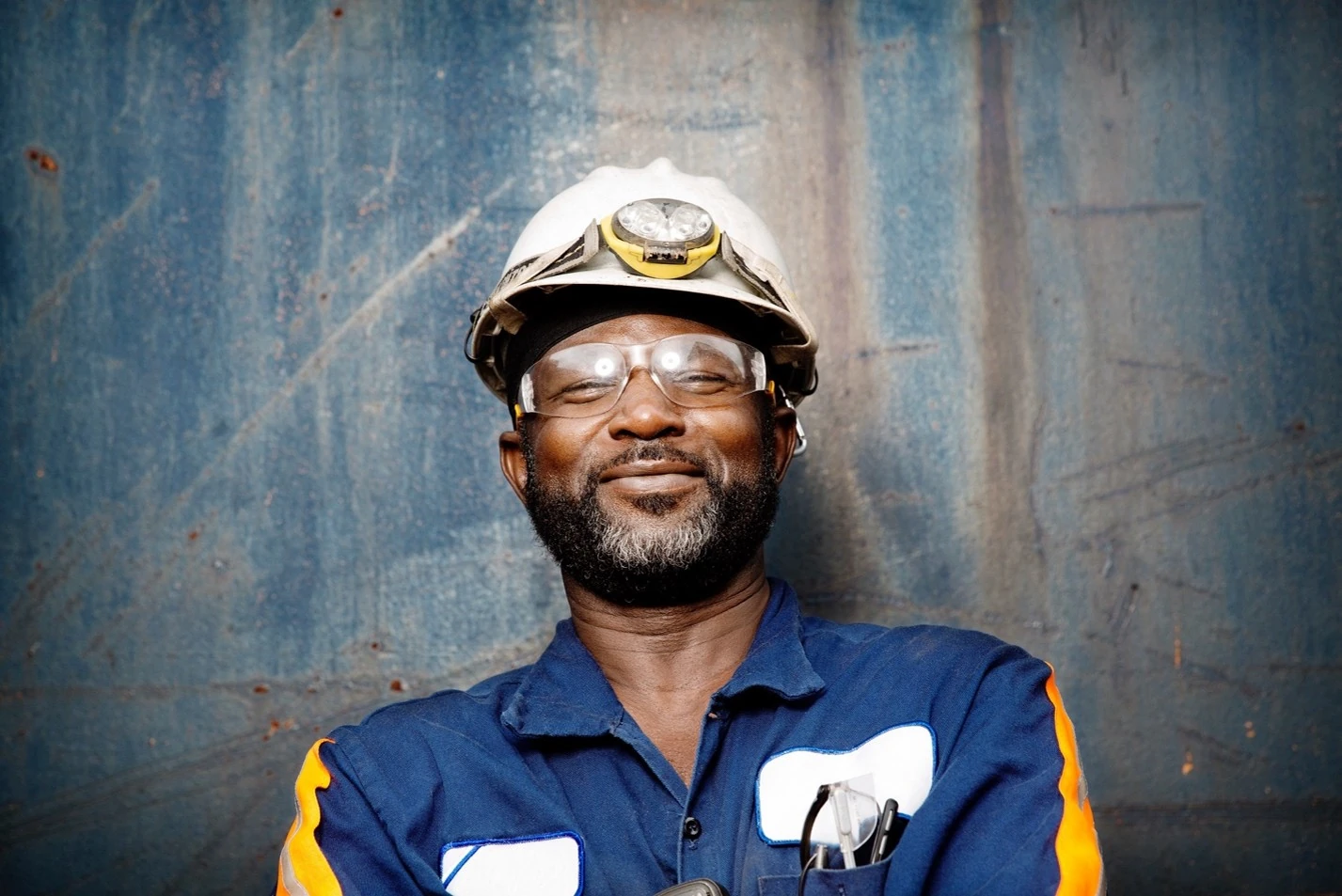 A construction worker geared up in a hard hat and safety glasses represents the readiness summer jobsites demand, protection that doesn't come at the cost of awareness.