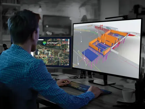 A CAD technician working with a 3D model on a computer.
