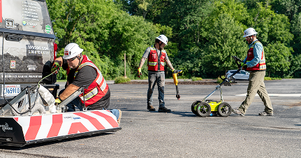 Three construction workers wearing hard hats and safety vests. - GPRS Images