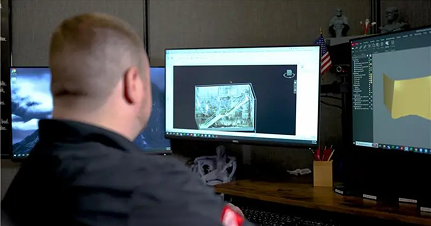 A man is standing in front of a computer screen. - GPRS Images