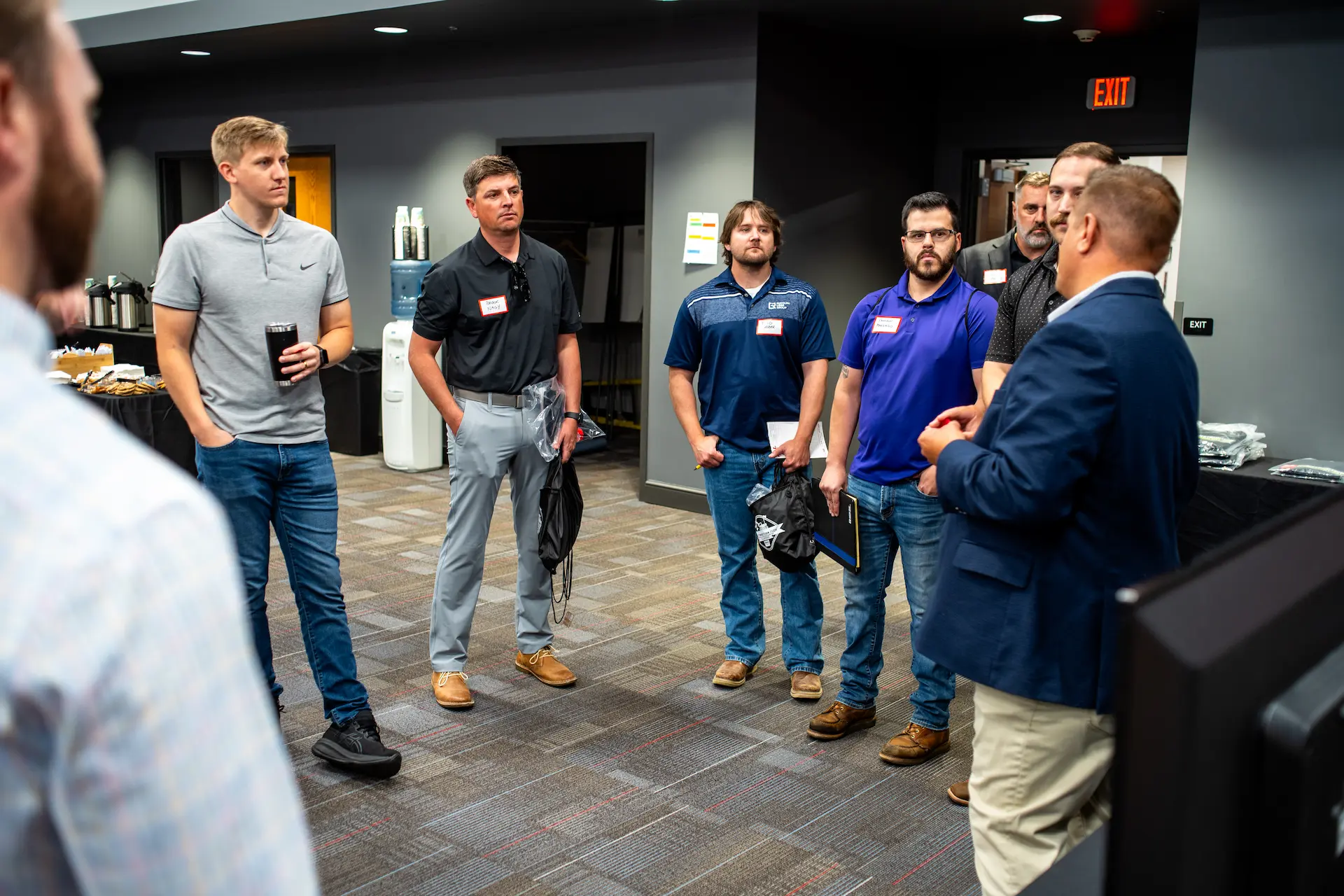 A presenter speaks to a group at GPRS Construction Tech Day, highlighting construction‑tech demonstrations, safety solutions, and efficient site‑management technologies.
