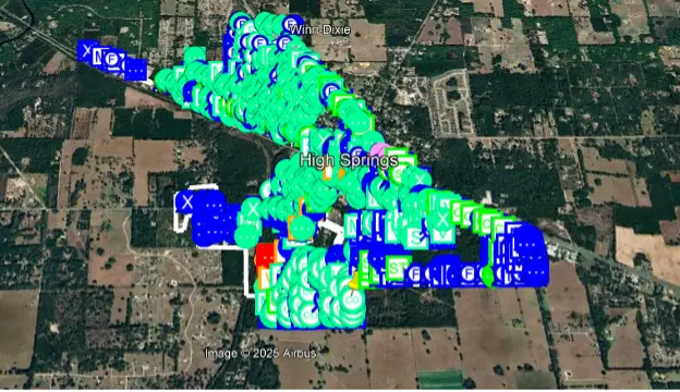 Satellite image displaying green and blue dots, representing marked utilities on the SiteMap Utility Data platform.