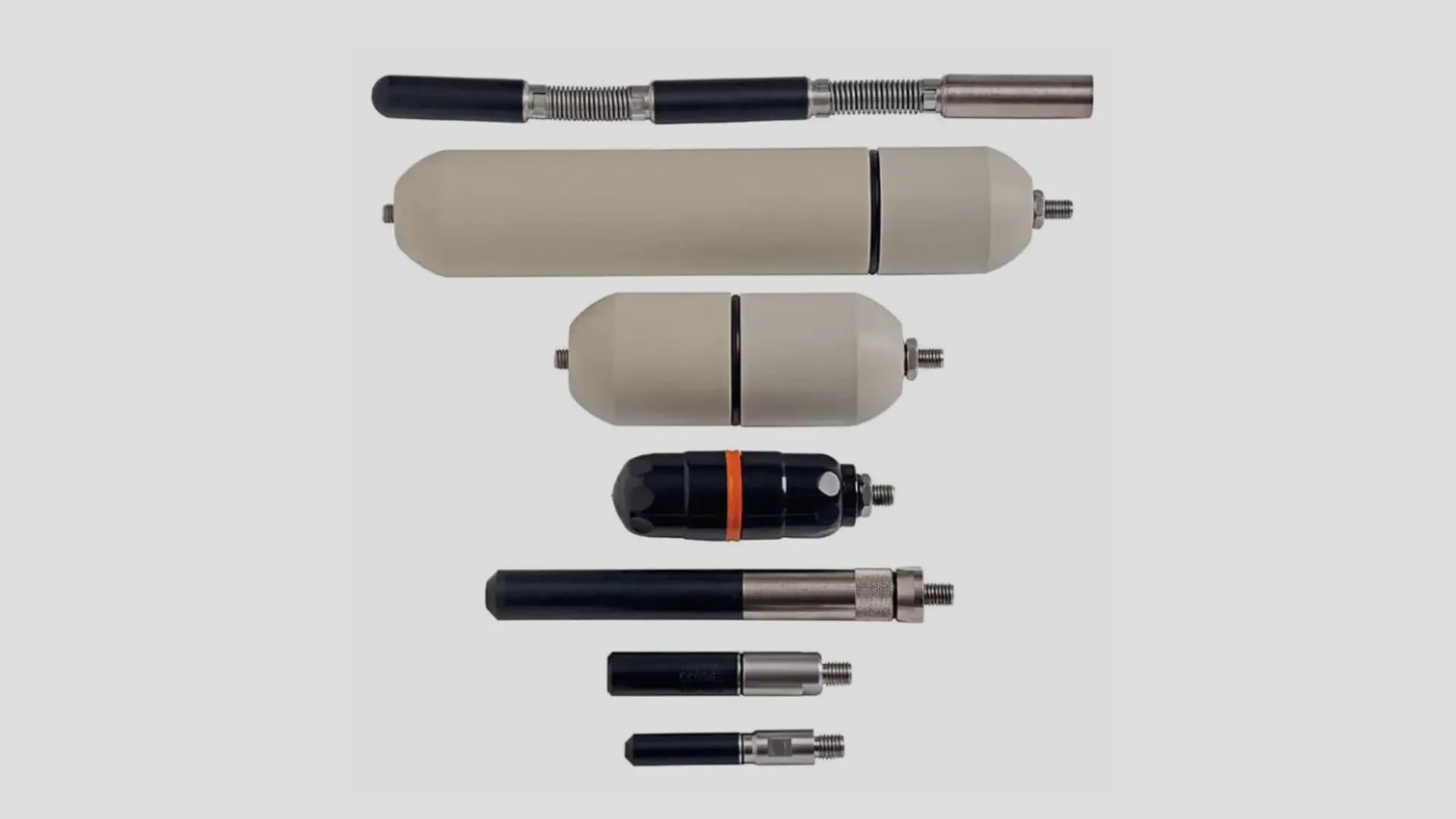Different types of sondes, small radio-frequency transmitters for accurate mapping of pipes, displayed together.
