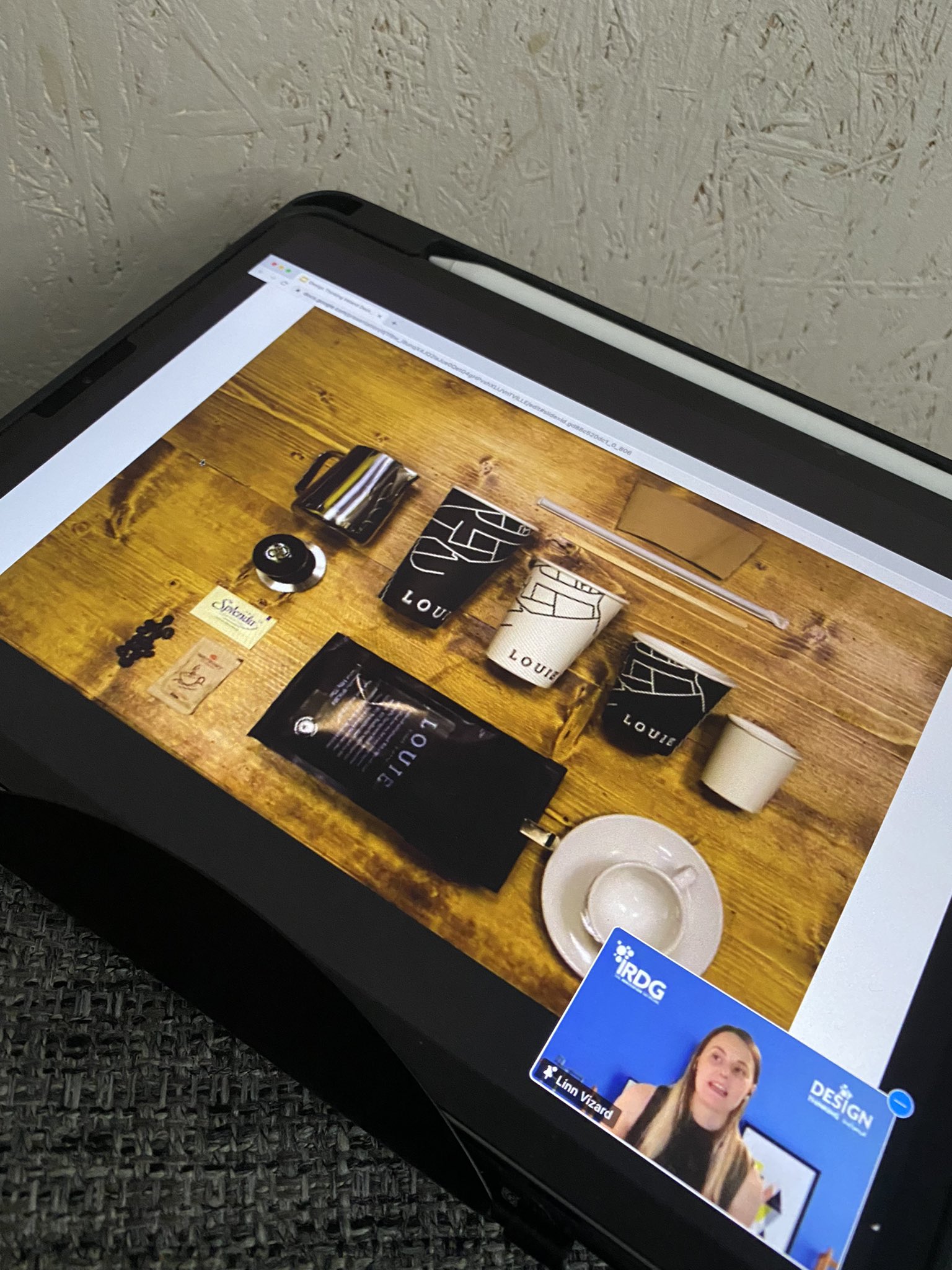 a tablet screen with Linn in the corner of a video call.