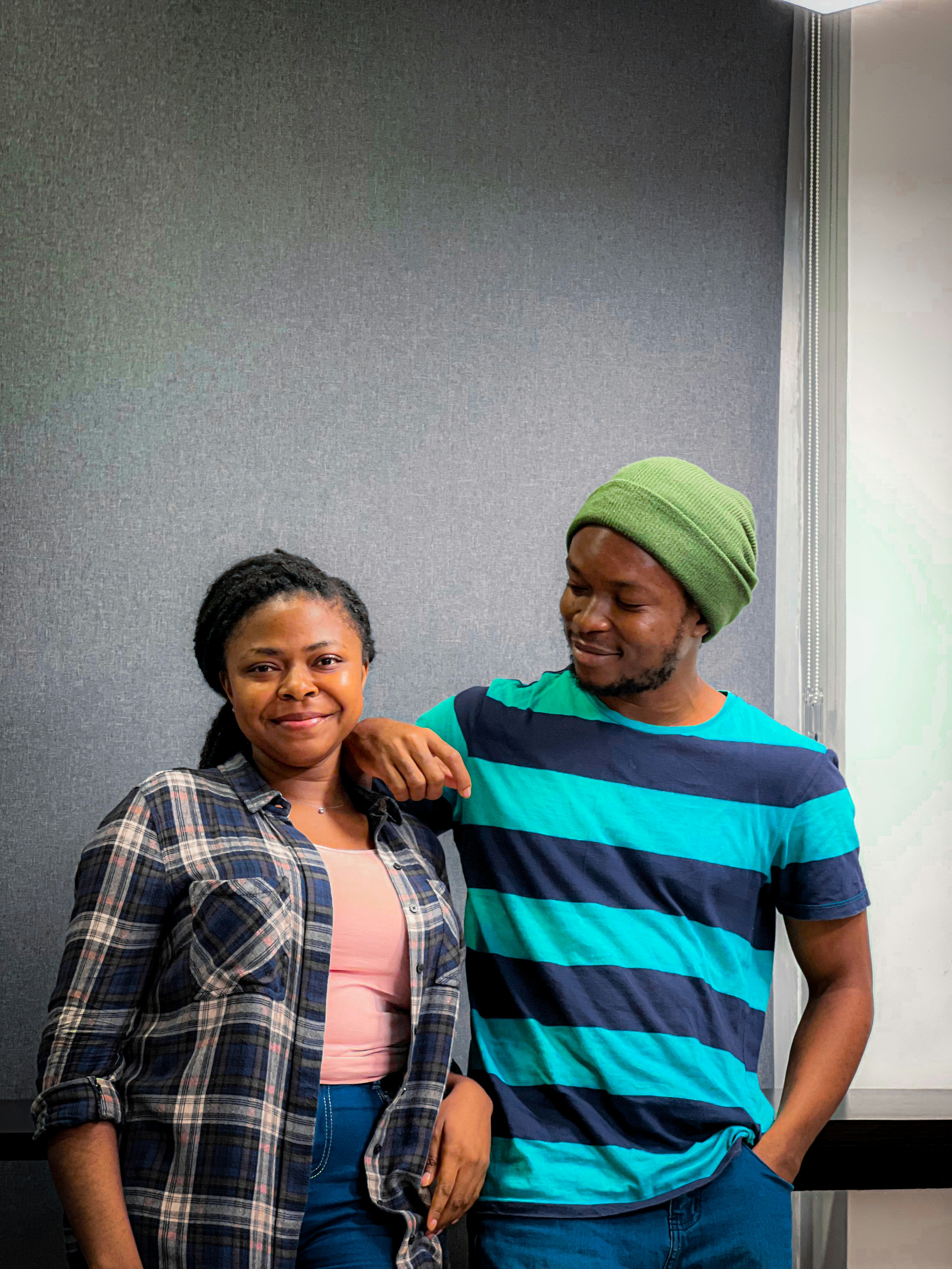 A young Black couple standing together and smiling