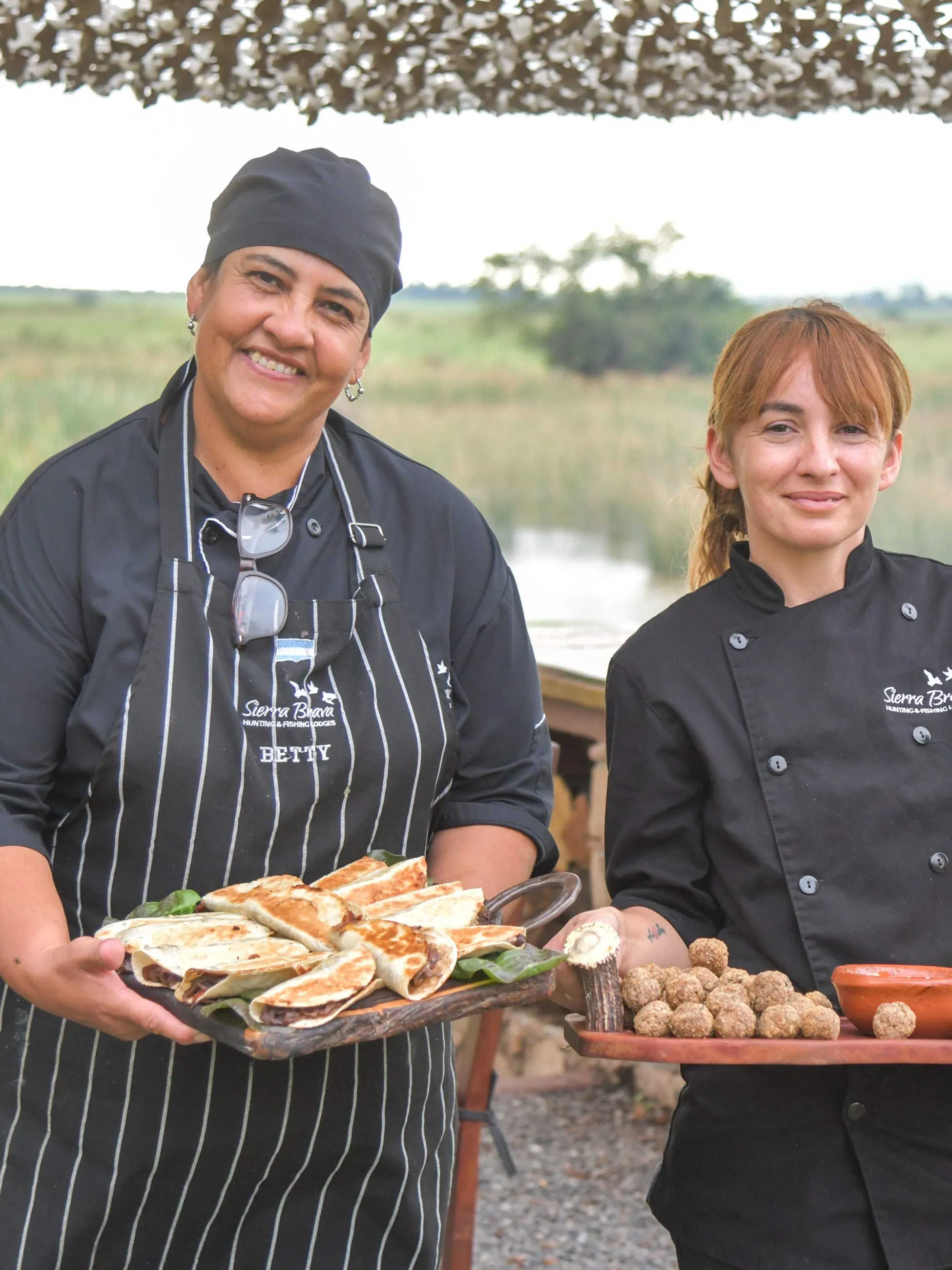 Cocineras del lodge con una bandeja recién horneada