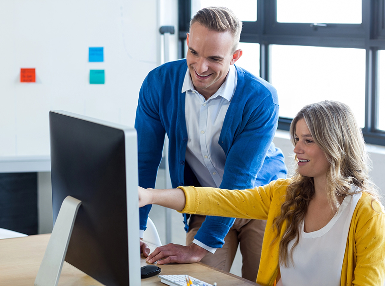 Healthcare marketing team reviewing data on a computer, representing funnel page creation and form optimization support through Veewz healthcare marketing services.