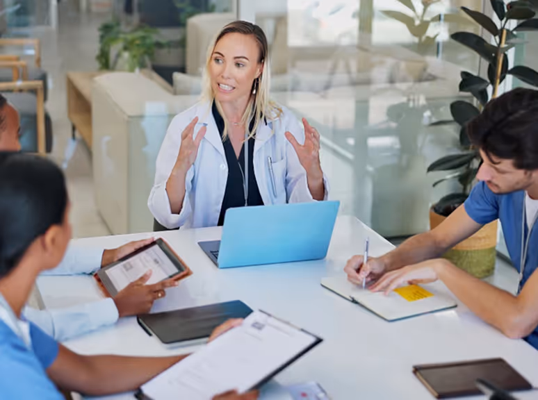 Healthcare professionals collaborating in a meeting, representing recruitment marketing assets and healthcare hiring support through Veewz healthcare marketing services.