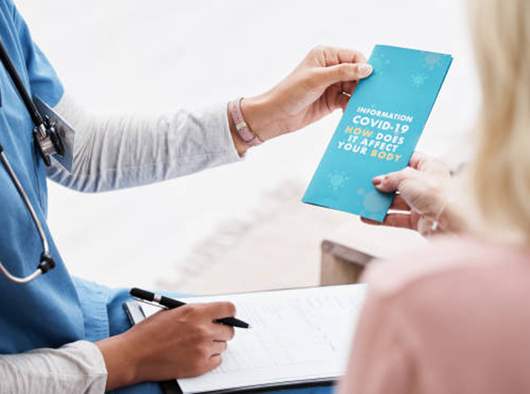 Hands exchanging a healthcare brochure, representing sales sheets, brochures, and flyer design services for healthcare marketing by Veewz.
