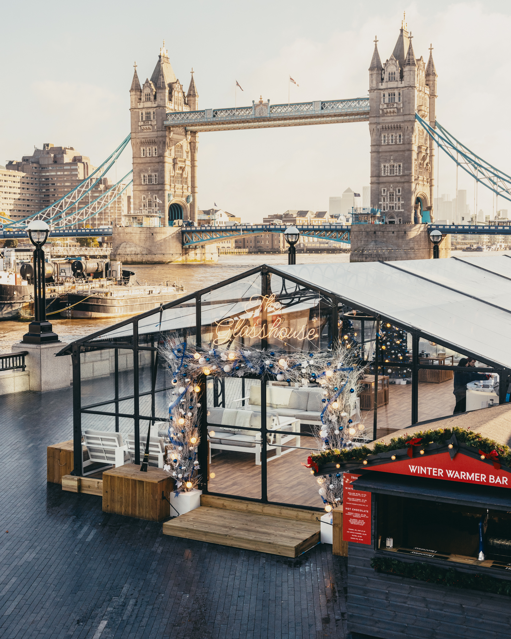 A temporary bar structure next to Tower Bridge for Winter By The River 2024.