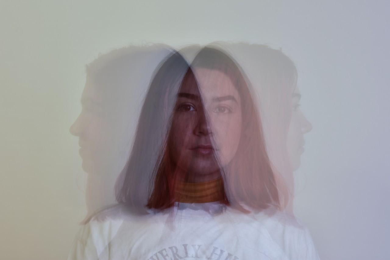 Ghosty image of a girl looking in three. different directions