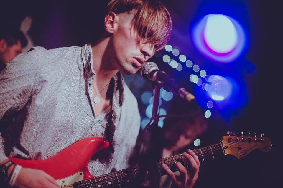 A man plays guitar to the audience
