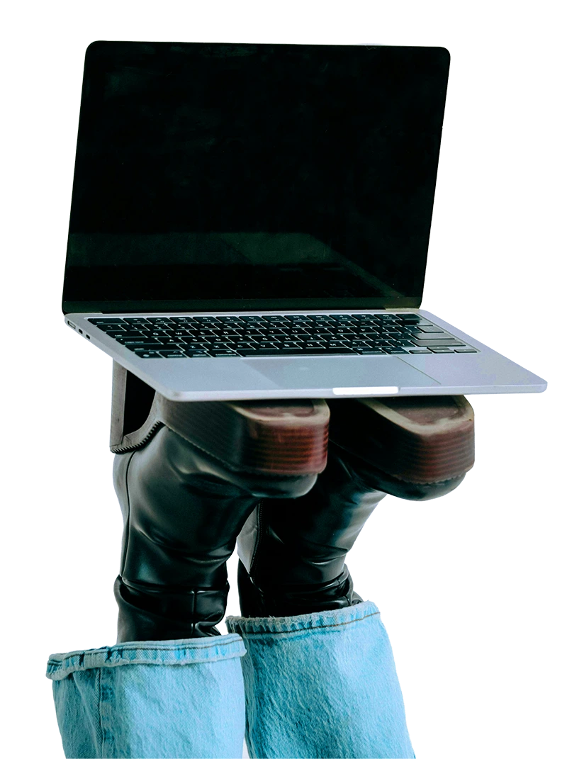 Playful laptop balancing on legs that are pointing to the sky