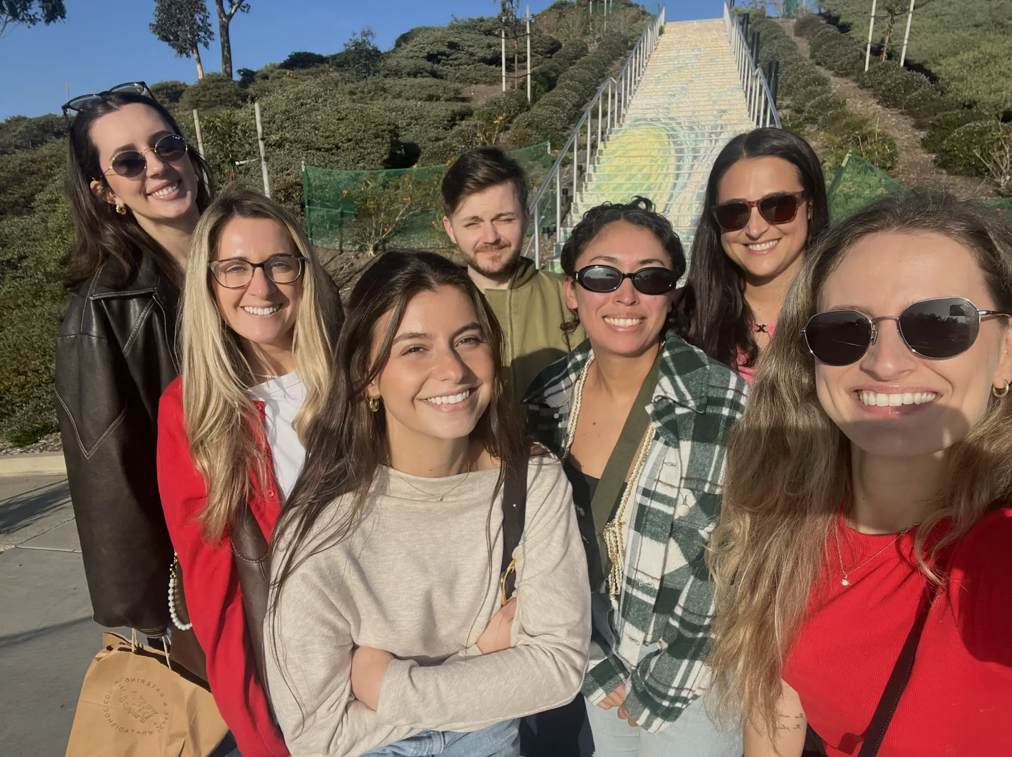 Klay Media team pictured smiling in front of scenic greenery background