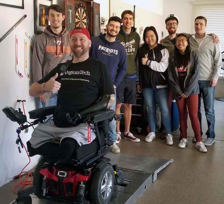 Virginia Tech students standing around their Challenger with his newly-completed project