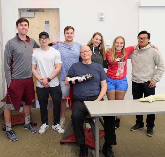 A group of students standing with their challenger and his completed project