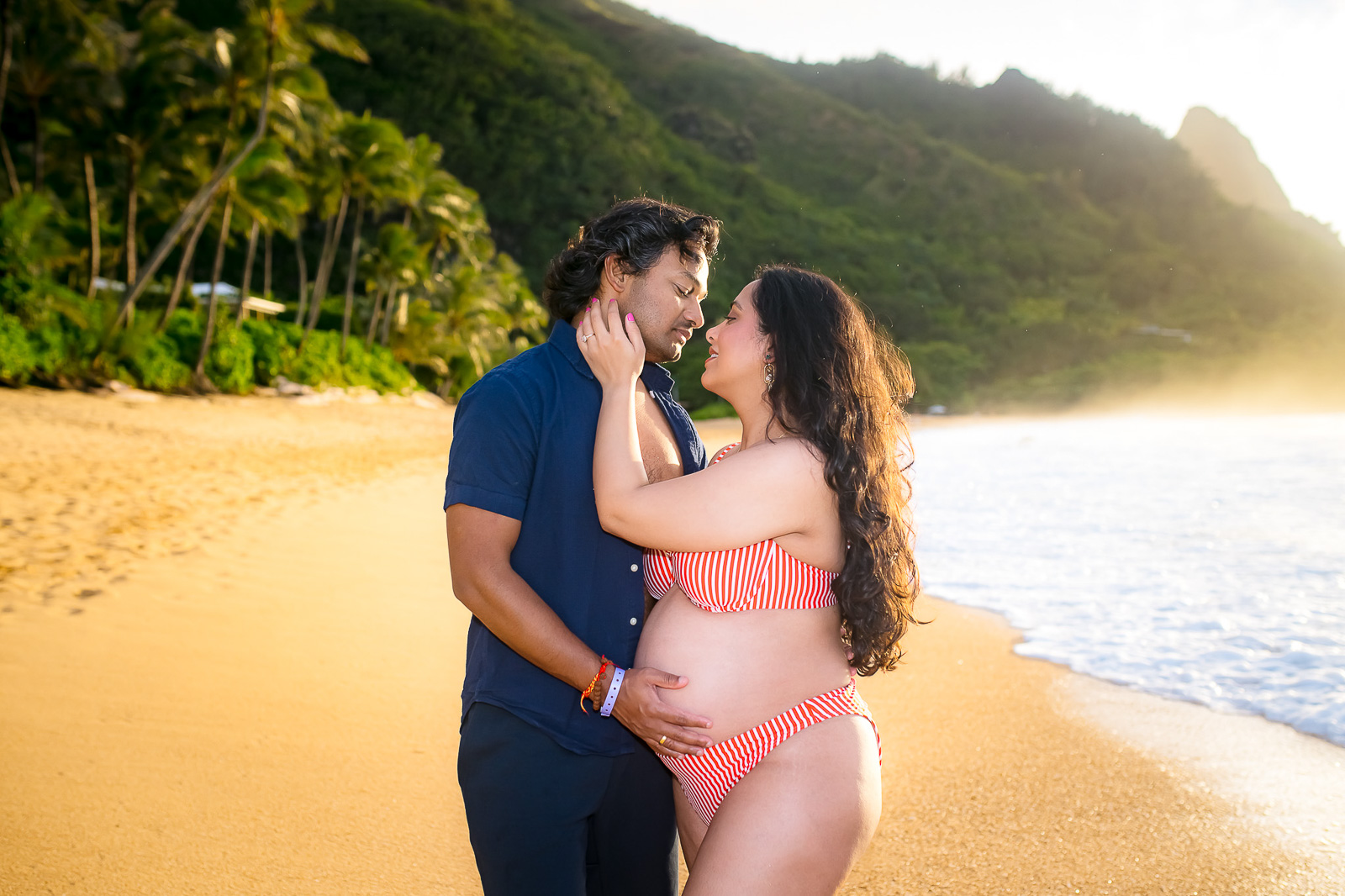 Couple share an intimate moment during their Kauai maternity photoshoot