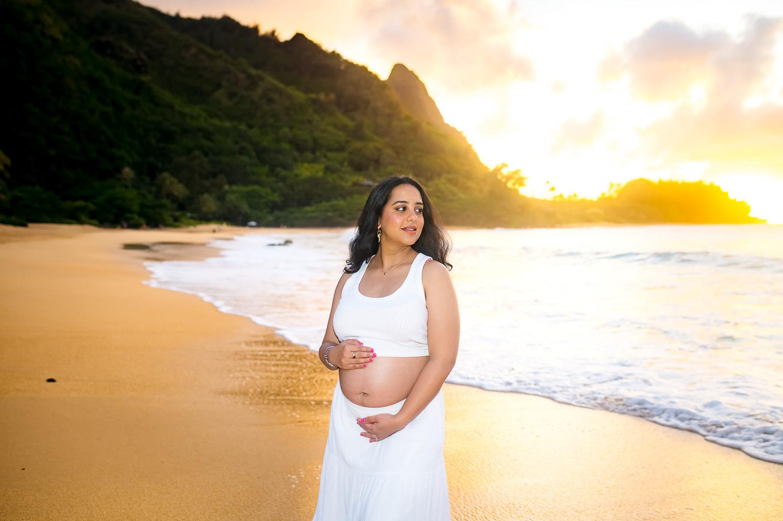 Serene maternity portrait of a beautiful woman at a Kauai beach.