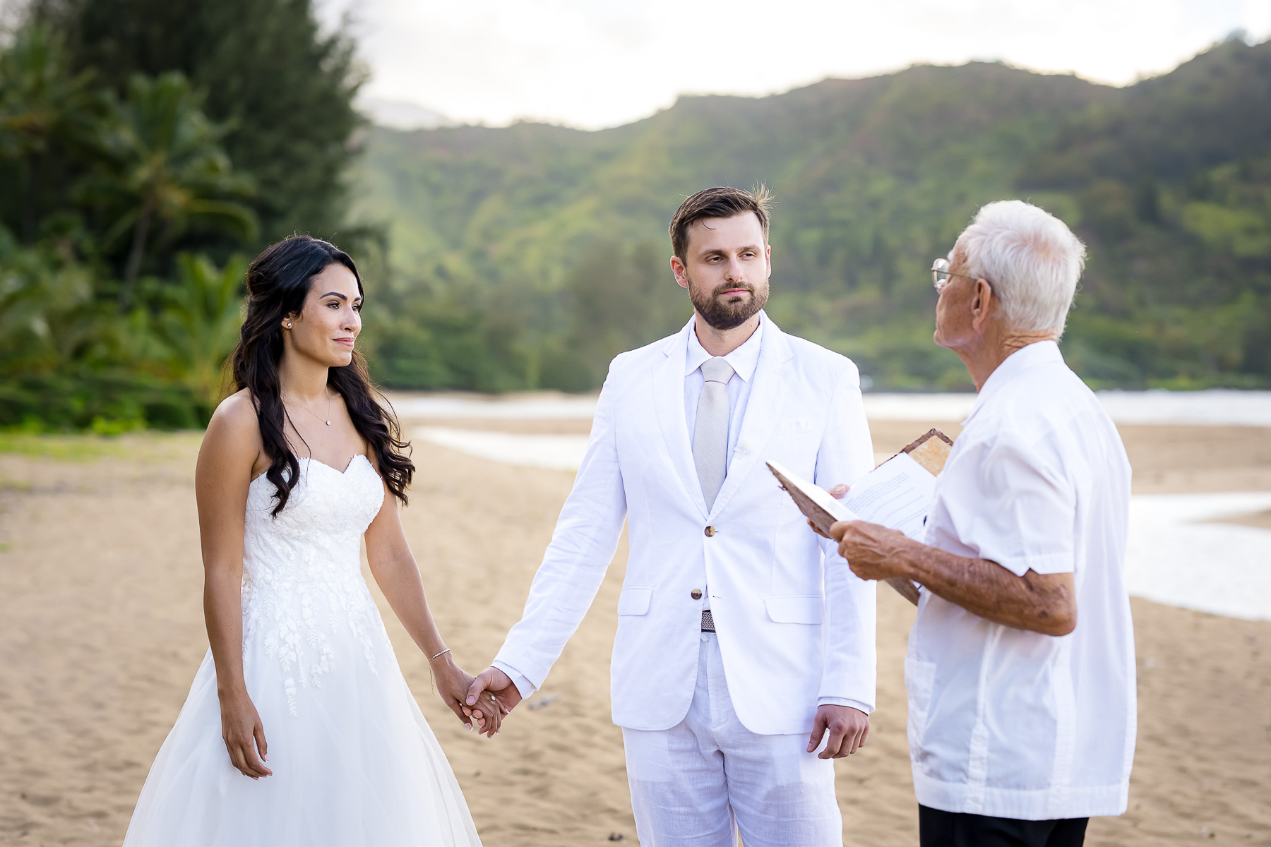 Elopement ceremony at Hanalei Bay captured by a Kauai elopement photographer during a peaceful beach wedding.